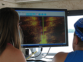 Nadine and Jeremy watch the sidescan sonar screen for anomalies.
