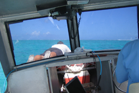 Brady Barrineau spotting coral heads on the bow of the
survey vessel.