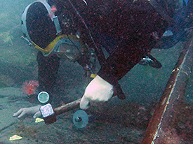 A diver dismantling the bow.