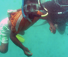 Kamal being escorted by Sanjeeva on his first visit to the site underwater .