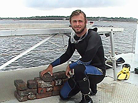 Brian with bricks collected from the Brick Wreck.