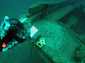 A diver documents the stern area.