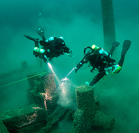 Divers examine spike driven into the windlass.