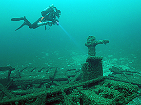 Diver surveying the rudder post and associated wreckage.