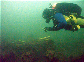 Survey work being performed by CLUE member Kevin Magee on the wooden barge (Photo by David VanZandt / CLUE).