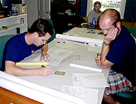 Adam and Joe transpose mylars onto the site map.