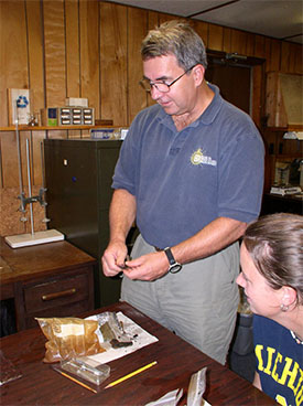 Dr Brad Rodgers shows how to remove concretions from an artifact before conserving it.