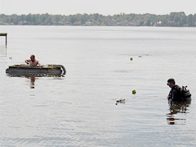 hile Joe sifts through the dredge spoil, Dr. Stewart oversees installation of the baseline.