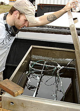 Brennan Bajdek observing chain in electrolytic reduction vat.