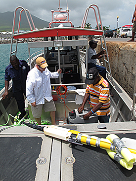 Preparing survey equipment on police launch.