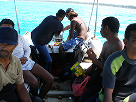 Elahena trying to start the out board motor on our boat.