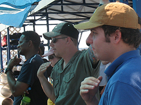 Guest Dr. Martin, Chad Gulseth, and Matt Gifford give the out of air sign during the safety brief on the UWF Barge.