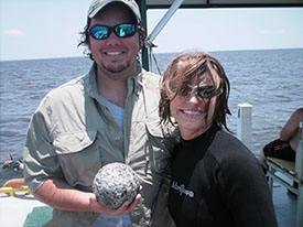 Team 3, Wes Perrine and Marisa Foster, show off the cannonball they excavated from the amidships unit.